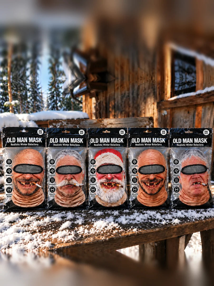 All five Old Man Mask designs in their packs on a snowy wooden bench: Original, Moustache, Santa, Bald and Grumpy