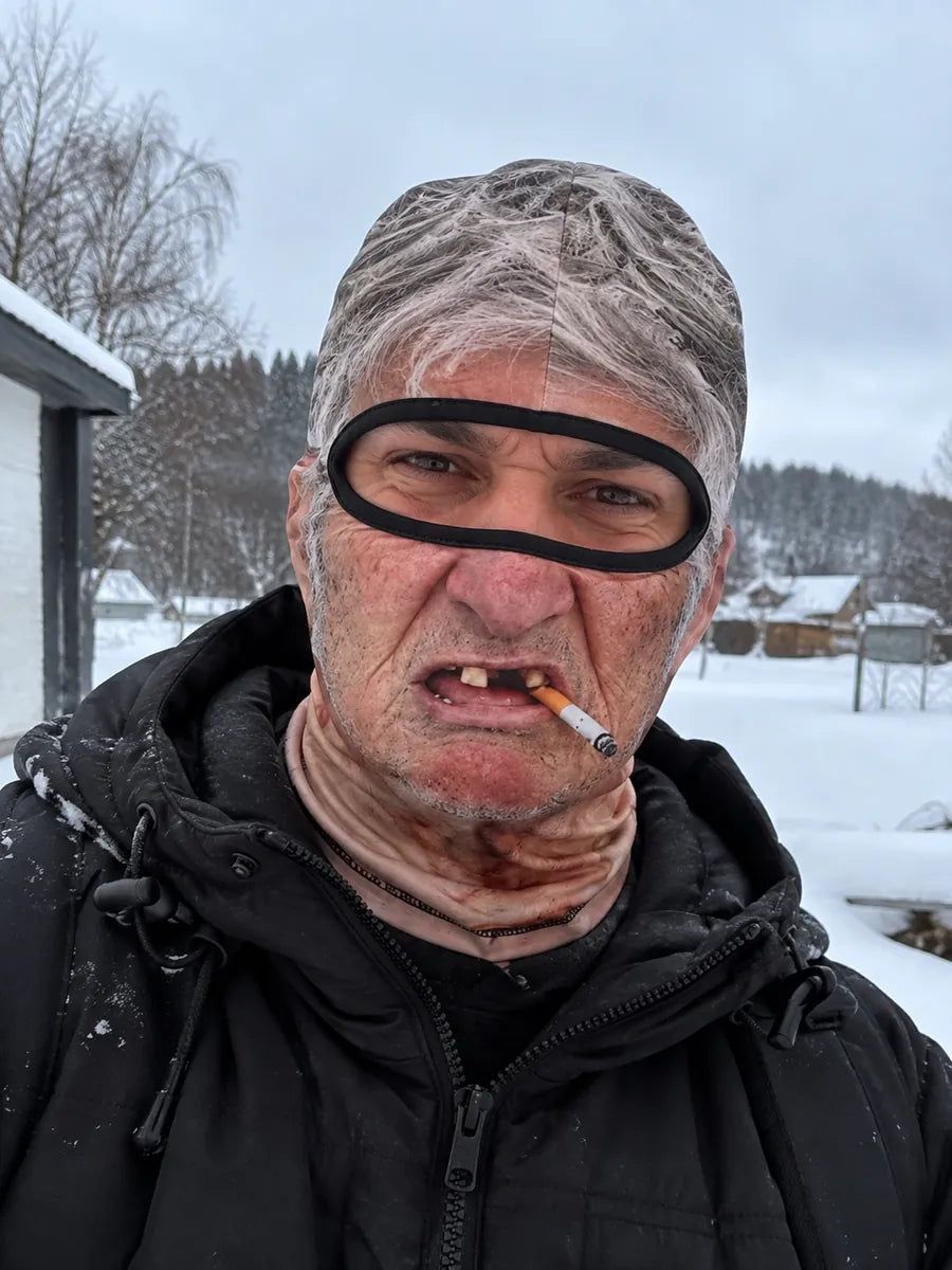 Person wearing the grey-haired Old Man Mask in the snow
